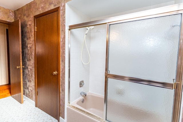 bathroom featuring shower / bath combination with glass door