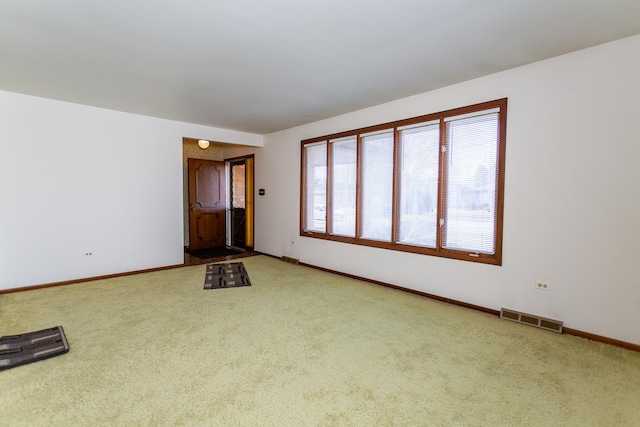 unfurnished living room featuring carpet