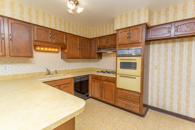 kitchen featuring light tile patterned floors, white appliances, and sink