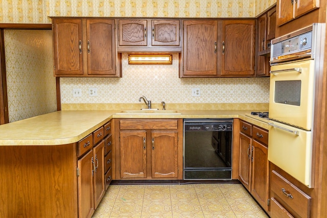 kitchen with kitchen peninsula, tasteful backsplash, dishwasher, and sink