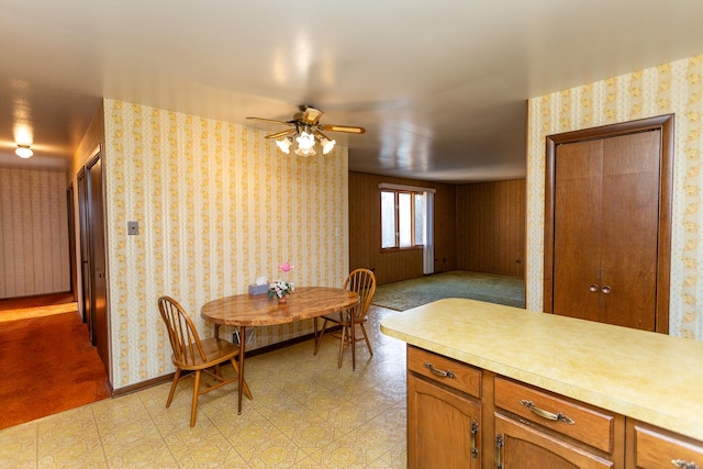 dining area with light carpet and ceiling fan