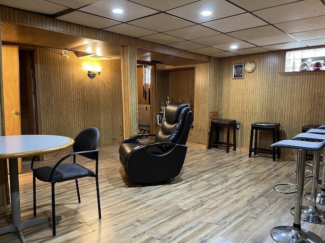 interior space featuring light hardwood / wood-style flooring and wood walls