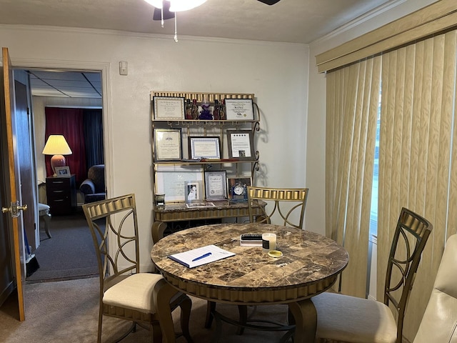 dining area with carpet floors, ceiling fan, and ornamental molding