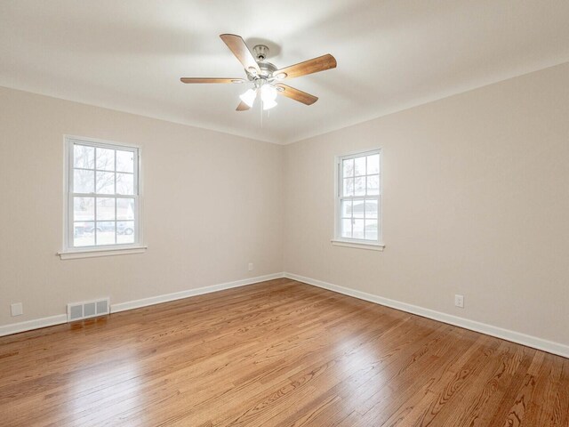 unfurnished room featuring ceiling fan, a healthy amount of sunlight, and light hardwood / wood-style flooring