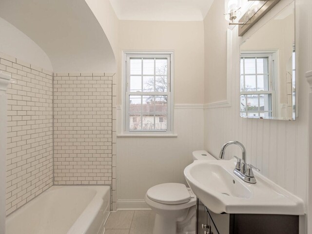 bathroom featuring tile patterned floors, vanity, toilet, and a bath