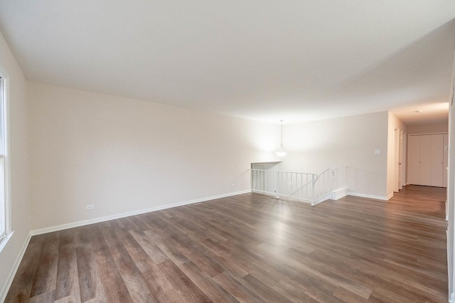 spare room featuring dark wood-type flooring