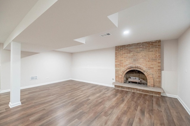 unfurnished living room featuring a fireplace and hardwood / wood-style flooring