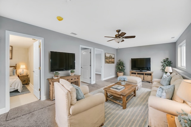 living room with ceiling fan and carpet floors