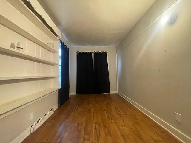 interior space featuring dark hardwood / wood-style flooring and a baseboard radiator