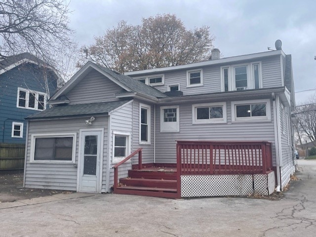 back of property with a wooden deck