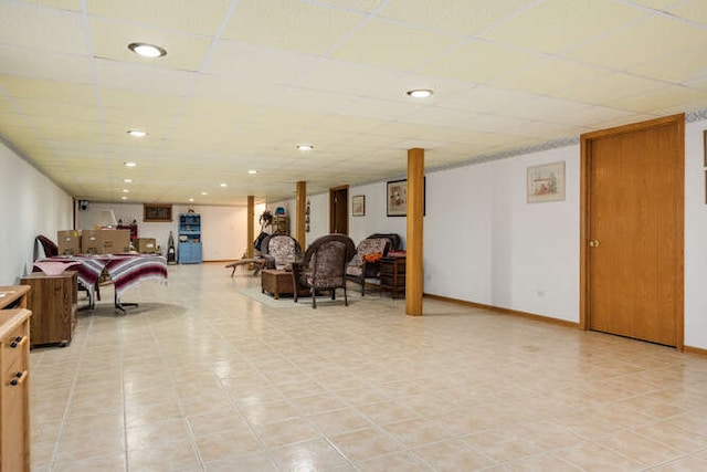 tiled living room featuring a paneled ceiling