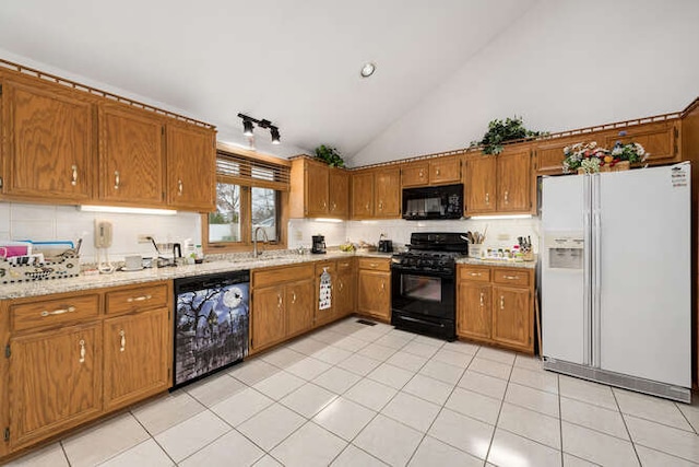 kitchen with sink, light stone counters, high vaulted ceiling, light tile patterned flooring, and black appliances