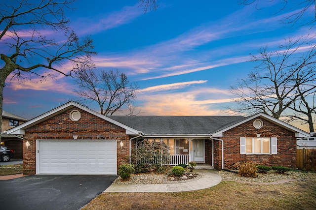 single story home featuring covered porch and a garage