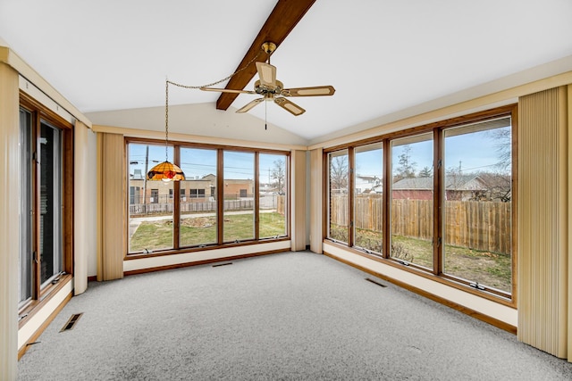 unfurnished sunroom with ceiling fan, lofted ceiling with beams, and a wealth of natural light