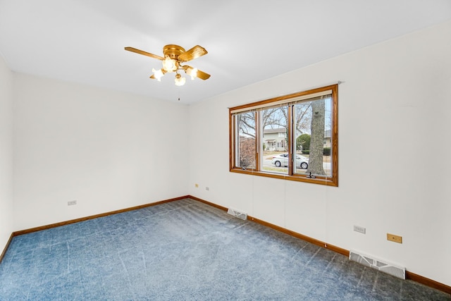 carpeted spare room with ceiling fan