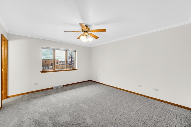 carpeted spare room featuring ceiling fan and crown molding