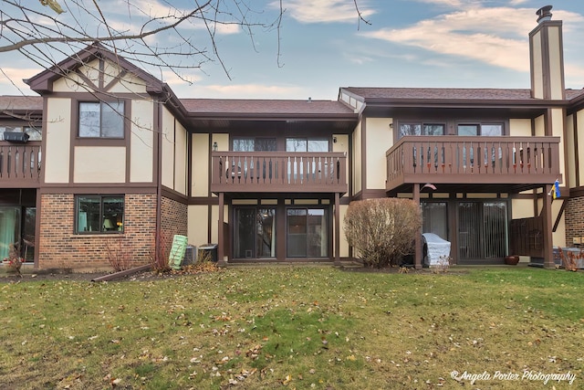 rear view of property featuring a yard and central AC