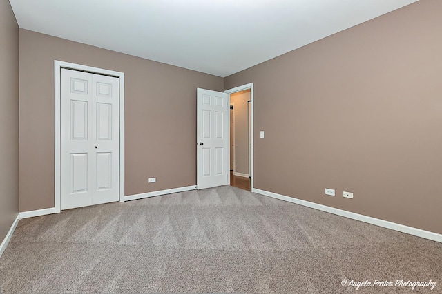 unfurnished bedroom featuring carpet flooring and a closet