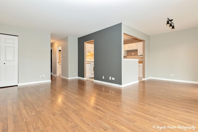 unfurnished living room with light hardwood / wood-style floors