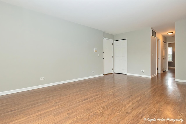 spare room with light hardwood / wood-style flooring