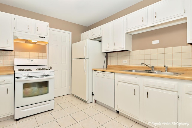 kitchen featuring sink, light tile patterned floors, white appliances, decorative backsplash, and white cabinets