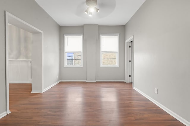 empty room featuring ceiling fan and dark wood-type flooring