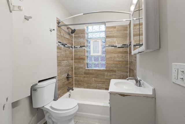 full bathroom with tiled shower / bath, vanity, a healthy amount of sunlight, and toilet