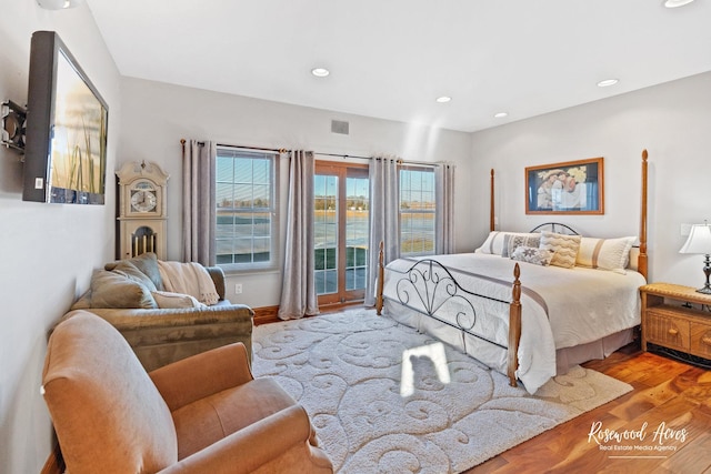 bedroom with access to outside and light hardwood / wood-style flooring