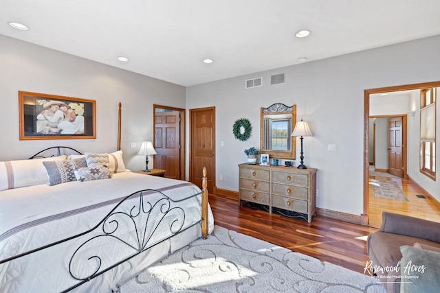 bedroom with dark hardwood / wood-style floors