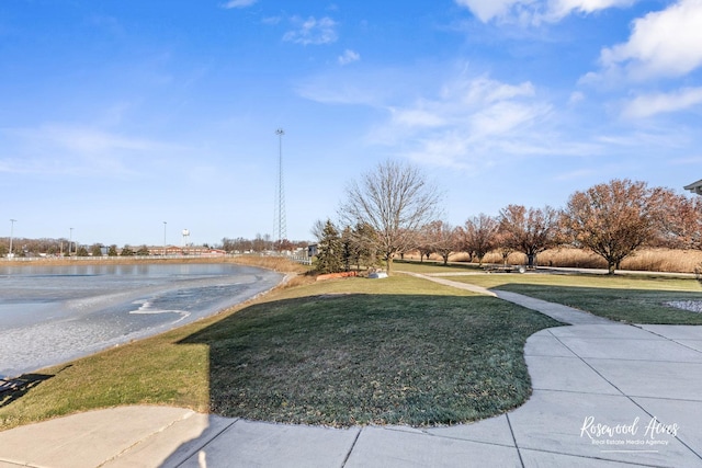 view of community with a lawn and a water view