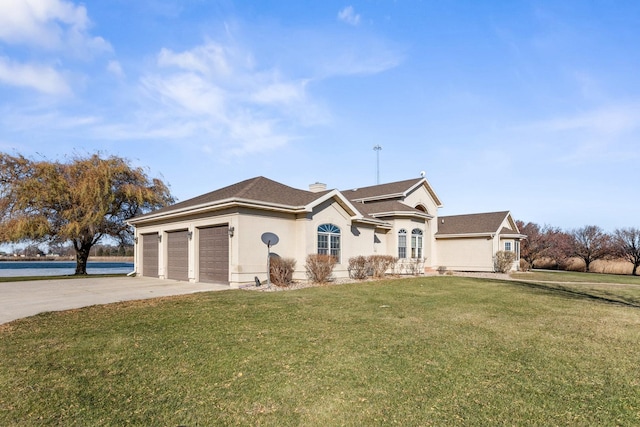 single story home with a water view, a garage, and a front lawn