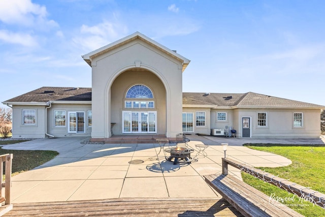 back of house featuring a patio area and an outdoor fire pit