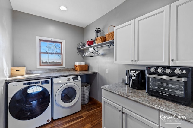 clothes washing area with dark hardwood / wood-style flooring and washing machine and clothes dryer