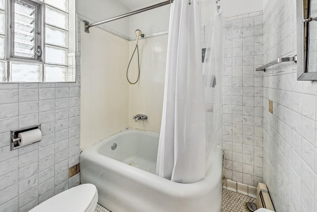 bathroom with tile walls, toilet, tile patterned floors, shower / bath combination with curtain, and a baseboard radiator