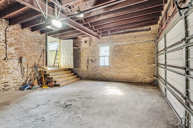 miscellaneous room featuring brick wall and concrete flooring