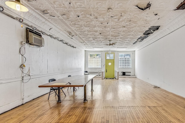 playroom featuring wood-type flooring and an AC wall unit