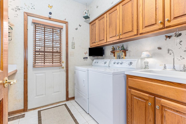 washroom with washer and clothes dryer, cabinets, light tile patterned floors, and sink