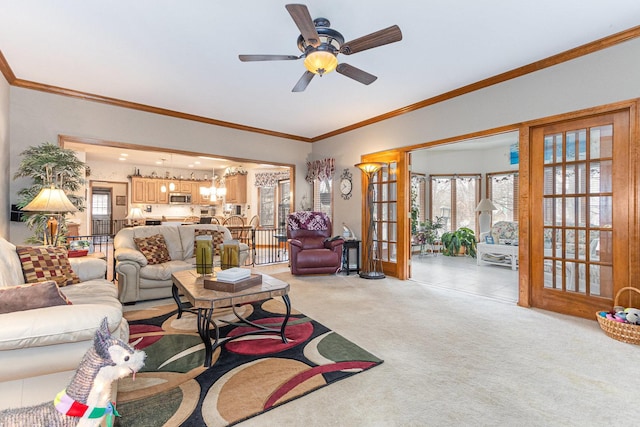 living room with crown molding, french doors, light colored carpet, and ceiling fan with notable chandelier