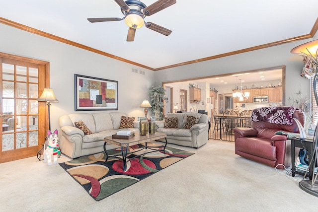 living room with crown molding, ceiling fan, and light carpet