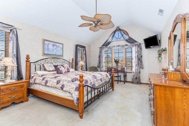 bedroom with multiple windows, light colored carpet, high vaulted ceiling, and ceiling fan