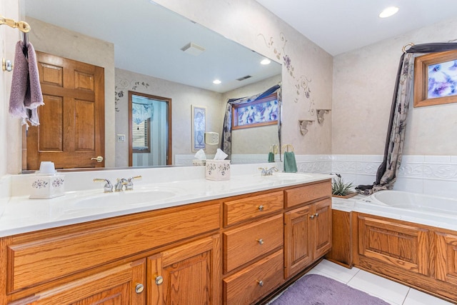 bathroom with tile patterned floors, vanity, and a tub