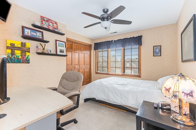 bedroom featuring ceiling fan, carpet floors, and a closet