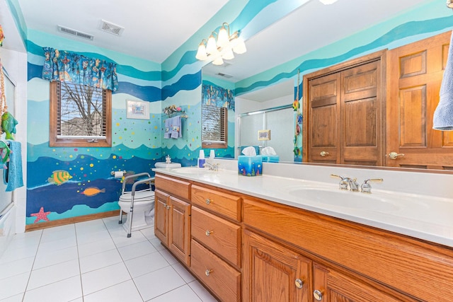 bathroom featuring tile patterned flooring, vanity, toilet, and a shower with shower door