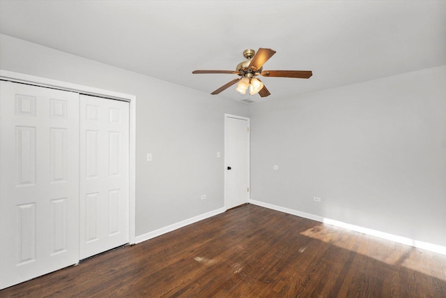 unfurnished bedroom featuring a closet, ceiling fan, and dark wood-type flooring