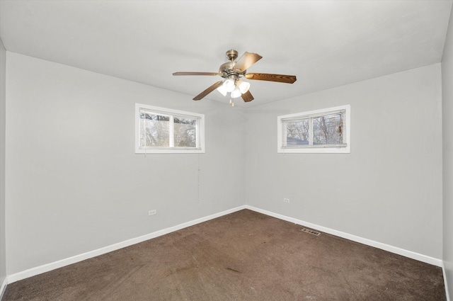 unfurnished room featuring dark colored carpet and ceiling fan