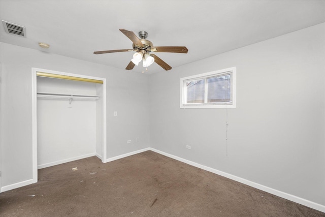 unfurnished bedroom featuring ceiling fan, a closet, and dark carpet