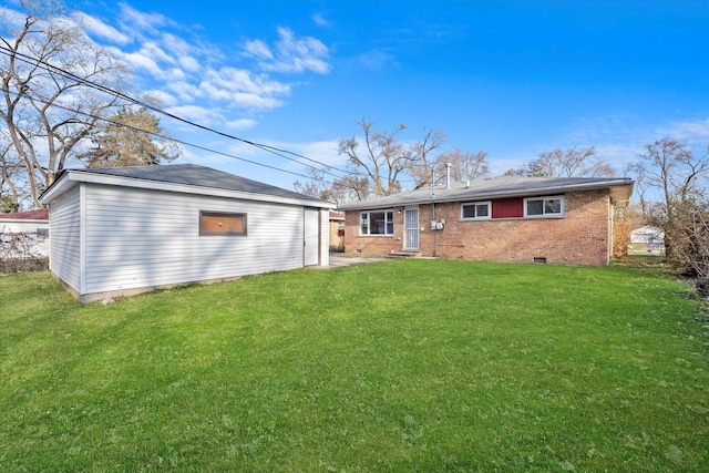 rear view of property with a lawn