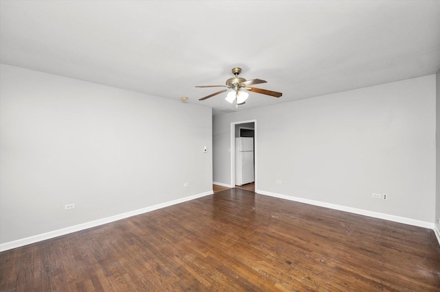 spare room featuring dark hardwood / wood-style floors and ceiling fan