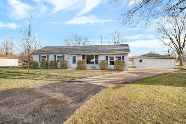 ranch-style home with a garage, an outbuilding, and a front yard