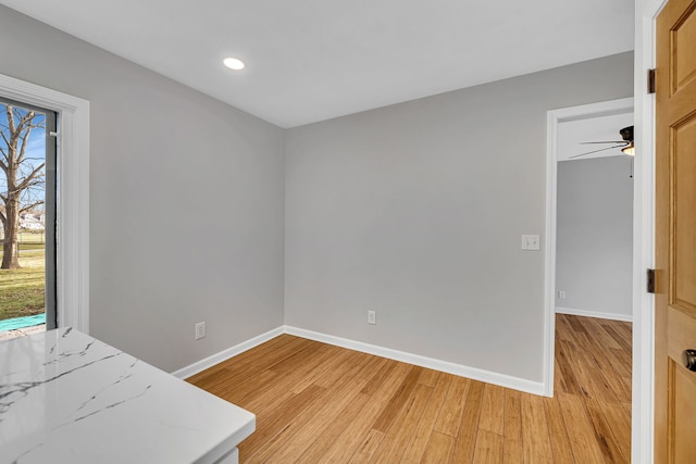 unfurnished room featuring light hardwood / wood-style flooring and ceiling fan